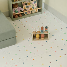 Load image into Gallery viewer, Children's toys on a polka dot floor with a teddy bear and alphabet letters in the background.