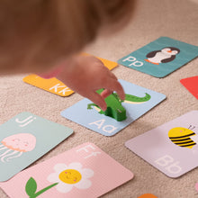 Load image into Gallery viewer, Child's hand interacting with alphabet on a carpeted floor