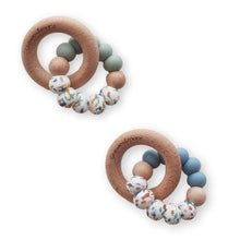 Load image into Gallery viewer, Two wooden teething rings with colorful beads on a white background