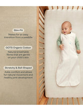 Load image into Gallery viewer, Baby in a white swaddle lying on a wooden crib with text about the product's features.