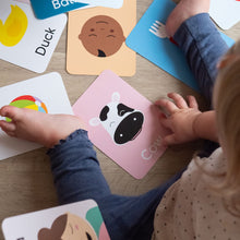 Load image into Gallery viewer, Child playing with educational cards featuring animals on a wooden surface