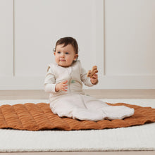 Load image into Gallery viewer, Baby sitting on a brown textured blanket in a minimalistic room.