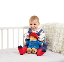 Load image into Gallery viewer, Baby in overalls sitting on a bed with a teddy bear