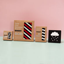 Load image into Gallery viewer, Collection of sensory boards with packaging on a light pink background