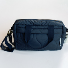 Load image into Gallery viewer, Navy blue quilted baby bag with a strap on a light grey background