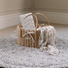 Load image into Gallery viewer, Wicker basket with scallop design baby muslin and travel changing mat on the Ralphie Bear Wildflower playmat.
