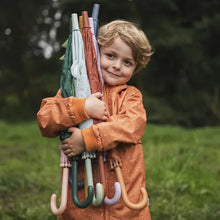 Load image into Gallery viewer, Boy in a raincoat holding a collection of umbrellas