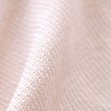 Load image into Gallery viewer, A close-up of a blush pink textured fabric with a soft, wavy drape.