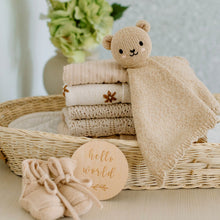 Load image into Gallery viewer, Stack of baby blankets with a knitted bear toy and 'hello world' sign in a wicker basket.