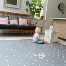 Load image into Gallery viewer, Child playing on a patterned floor with toys in a living room.