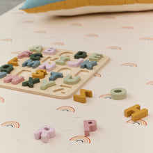 Load image into Gallery viewer, Colorful wooden alphabet puzzle on a soft surface with rainbow patterns
