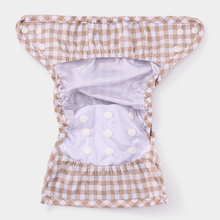 Load image into Gallery viewer, Inside of a checkered nappy wrap with white press studs on a white background