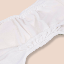 Load image into Gallery viewer, Close-up of the inide of a white cloth nappy on a beige surface