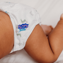 Load image into Gallery viewer, Close-up of a baby wearing a white cloth nappy with a official Peppa Pig label.