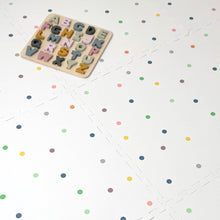 Load image into Gallery viewer, Wooden alphabet puzzle on a white surface with colourful polka dots