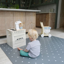 Load image into Gallery viewer, Child playing with a toy kitchen set on a patterned rug in a kitchen.