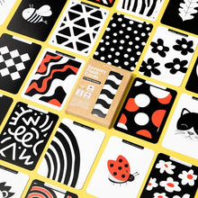 Load image into Gallery viewer, Collection of black, white, and red patterned cards on a yellow background with a box labeled 'Sensory Flash Cards'.
