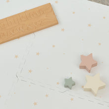Load image into Gallery viewer, Star-shaped wooden toys on a white surface with star patterns
