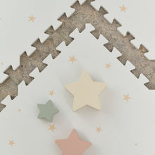 Load image into Gallery viewer, Star-shaped toys on a textured surface with star patterns
