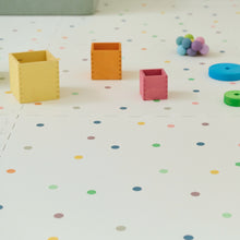 Load image into Gallery viewer, Colourful children's toys on a polka dot play mat
