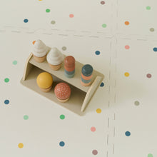 Load image into Gallery viewer, Colourful wooden toy ice cream set on a shelf against a polka dot background
