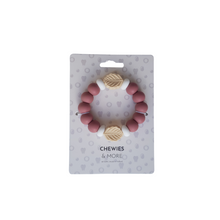 Load image into Gallery viewer, Teething ring with pink beads and leaf-shaped components on a 'Chewies &amp; More' branded card.
