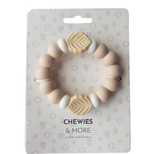 Load image into Gallery viewer, Baby teething ring with leaf designs on a 'Chewies &amp; More' branded package.
