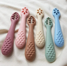 Load image into Gallery viewer, Set of six colourful baby teethers on a soft fabric background
