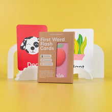 Load image into Gallery viewer, Box of 'First Word Flash Cards' with colorful flash cards on a yellow background
