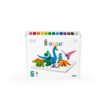 Load image into Gallery viewer, Box of Hey Clay dinosaur figurines with colorful clay cans on a white background

