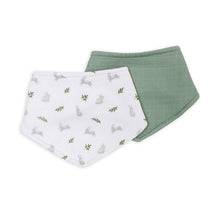Load image into Gallery viewer, Two bandana bibs one with bunnies and green leaf pattern the other a solid fern colour on a white background. 
