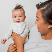 Load image into Gallery viewer, Woman holding a baby wearing a greenery patterned bib against a plain background
