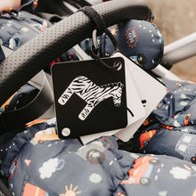 Load image into Gallery viewer, Black and white sensory cards with zebra design in a stroller

