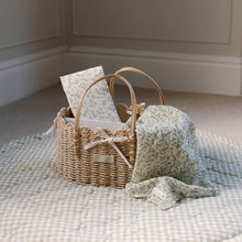 Load image into Gallery viewer, Wicker basket with fern design baby muslin and travel changing mat on a sage checkered playmat against a neutral wall.
