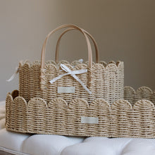 Load image into Gallery viewer, Woven basket with handles on a white surface against a beige wall
