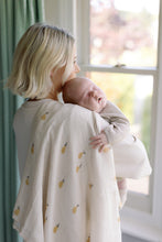 Load image into Gallery viewer, Woman holding a baby wrapped in a blanket with pineapple patterns in a bright room.
