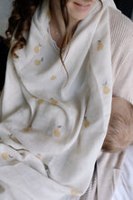 Load image into Gallery viewer, Woman wearing a muslin with Ralphie Bear pear design covering a baby feeding.
