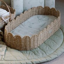 Load image into Gallery viewer, Woven changing basket with decorative scalloped edge on a soft green surface
