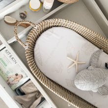 Load image into Gallery viewer, Woven basket with seashell basket liner and baby items in a changing table
