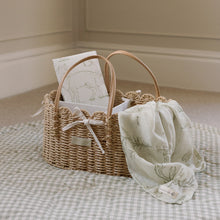 Load image into Gallery viewer, Wicker basket with woodland design baby muslin and travel changing mat on a checkered Ralphie Bear playmat
