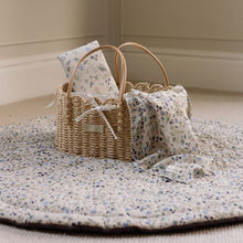 Load image into Gallery viewer, Wicker basket with wildflower design muslin and travel cahnging mat on the Ralphie Bear Wildflower playmat.
