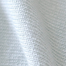 Load image into Gallery viewer, A close-up of a light blue knitted fabric with a textured, ribbed pattern, shown with soft folds.
