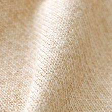 Load image into Gallery viewer, Close-up of a cream-colored knit fabric with a soft, textured weave and gentle folds.
