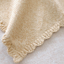 Load image into Gallery viewer, Close-up of a beige knitted blanket on a light background
