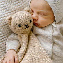 Load image into Gallery viewer, Newborn baby sleeping with a knitted teddy bear on a textured blanket
