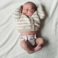 Load image into Gallery viewer, Newborn baby wrapped in a striped cardigan on a white blanket
