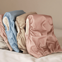 Load image into Gallery viewer, Set of four colourful cloth nappies  on a neutral background
