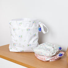 Load image into Gallery viewer, White patterned bag with folded cloth nappies on a wooden surface
