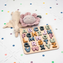 Load image into Gallery viewer, Wooden alphabet puzzle with colourful letters on a white surface with polka dot patterns.
