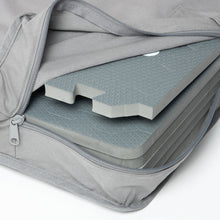 Load image into Gallery viewer, Grey foam mats stacked inside a grey bag on a white background
